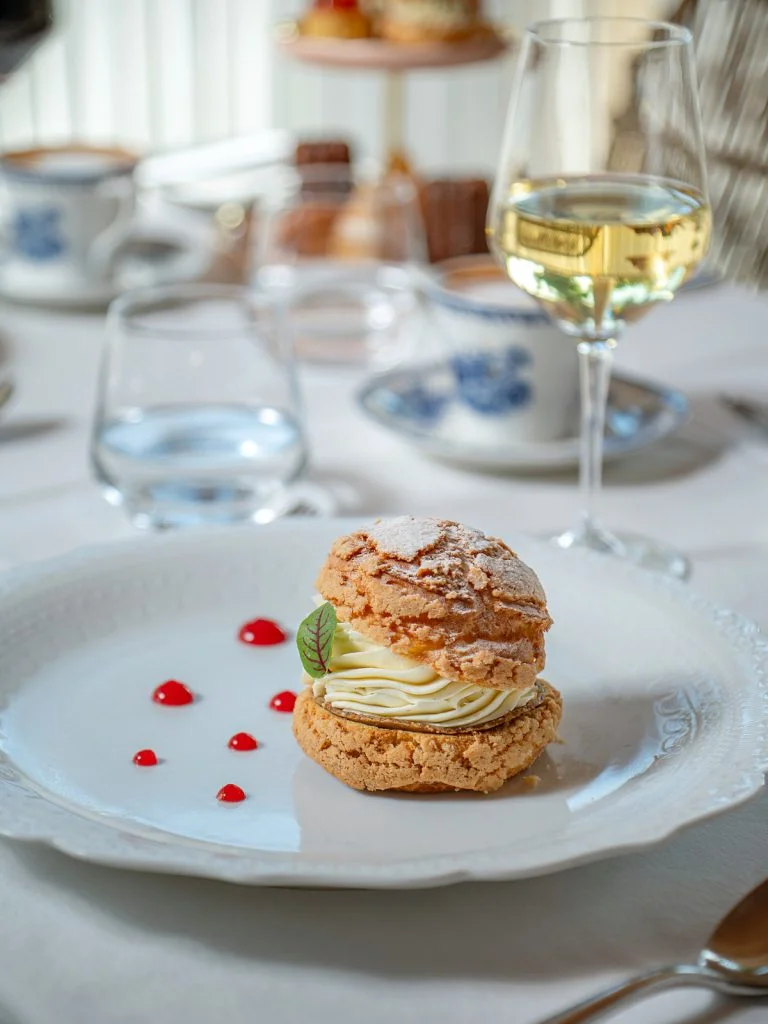 Chou à la Chantilly, a Vanilla Cream Puff handcrafted in L’Atelier, served with a glass of white wine at Gooseberry, Uluwatu