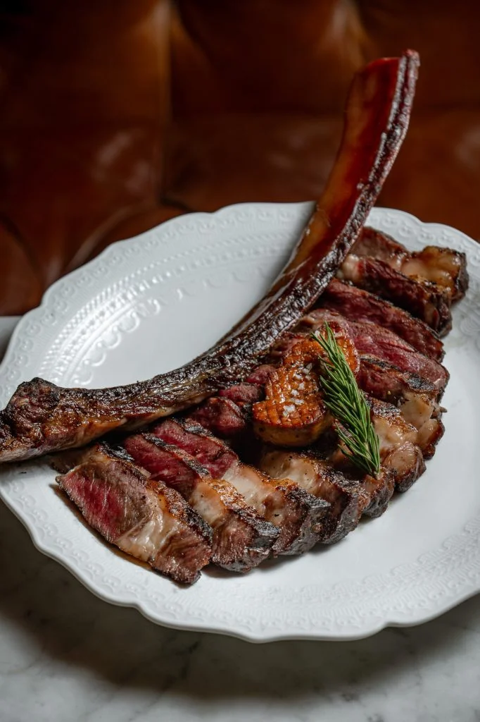 Côte de Bœuf Wagyu, a sliced tomahawk ribeye with pan-seared foie gras, served at Gooseberry French Restaurant, Uluwatu